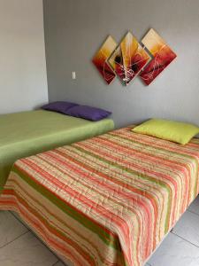 a bedroom with a bed with two paintings on the wall at Lofts Paraíso de Alcobaça in Alcobaça