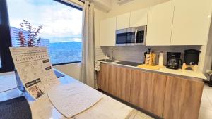 a kitchen with a counter with a microwave and a window at Unique Studio Apartment in the heart of Guatemala City in Guatemala