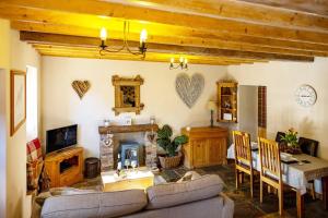 a living room with a couch and a fireplace at The Barn, rustic country cottage dog friendly in Whitby