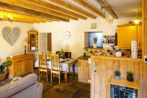 a kitchen and dining room with a table and chairs at The Barn, rustic country cottage dog friendly in Whitby