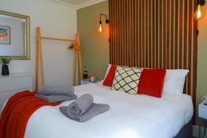 a bedroom with a white bed with towels on it at The Court Yard Apartment - Fantastic location! in Scarborough