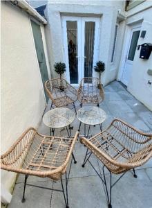 a group of chairs and tables on a patio at The Court Yard Apartment - Fantastic location! in Scarborough +35 photos