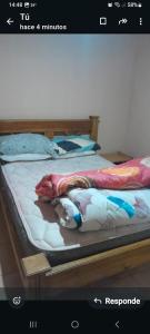 a picture of a bed with a blanket on it at Cabañas Las Dunas in El Nihuil