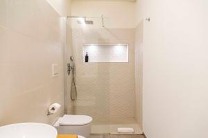 a bathroom with a shower with a toilet and a sink at Taormela 1 - Holiday Apartment in Taormina +21 photos