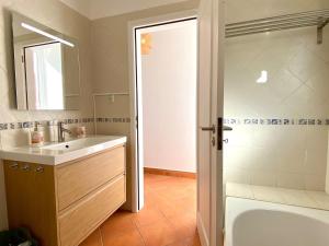 a bathroom with a sink and a tub and a mirror at Portugal Secret 2 by CORAL - Townhouse rooftop in Portimão +22 photos