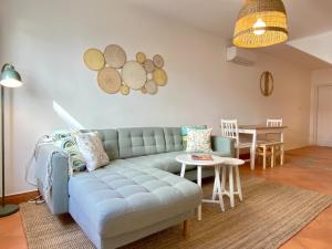 a living room with a blue couch and a table at Portugal Secret 2 by CORAL - Townhouse rooftop in Portimão