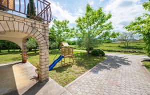 un cortile con parco giochi e altalena di 2 Bedroom Pet Friendly Home In Lazarici a Potpićan
