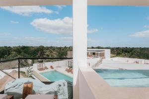 a view from the balcony of a house with a swimming pool at Casa Reina Tulum in Tulum