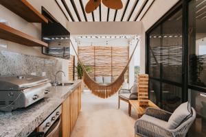 a kitchen with a hammock hanging from the ceiling at Casa Reina Tulum in Tulum