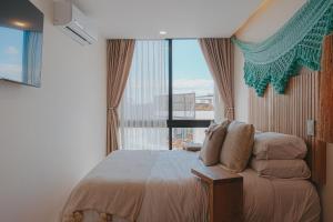 a bedroom with a bed and a large window at Casa Reina Tulum in Tulum +19 photos
