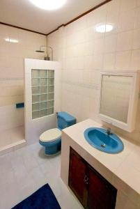 a bathroom with a blue sink and a toilet at TheStarHome Sukhumvit71 in Bangkok +16 photos