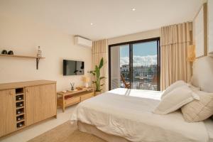 a bedroom with a large bed and a television at Studio rénové avec vue mer in Grimaud