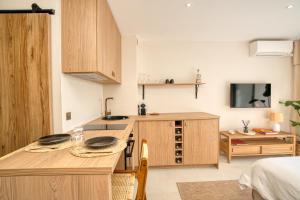 a kitchen with a table with two plates on it at Studio rénové avec vue mer in Grimaud