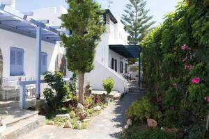 a garden in front of a white house at PAROS APARTMENT MELAS α1 in Parikia +25 photos