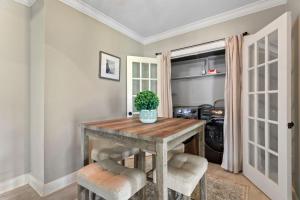 a dining room with a wooden table and chairs at Downtown Cottage in Lake Charles