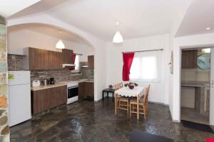 a kitchen with a table and a dining room at PAROS APARTMENT MELAS α1 in Parikia