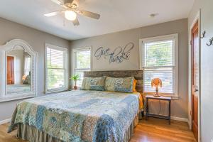 a bedroom with a bed and a ceiling fan at 1 Mi to Dtwn Family-Friendly Brenham Bungalow! in Brenham