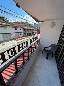 a balcony with a chair sitting on top of a building at Hotel boutique San Pablo H3 in Medellín +9 photos