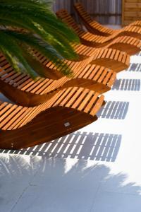 a row of wooden chairs sitting on top of a table at La Garoupe-Gardiole in Antibes