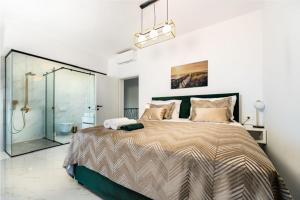 a bedroom with a large bed and a glass shower at Villa Adria Maria 2 in Privlaka +28 photos
