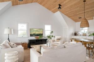 a living room with white furniture and a wooden ceiling at Ocean Views Pool Hot Tub & 7Min Walk to Beach in Corolla