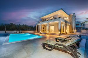 a house with a swimming pool in front of it at Villa Adria Maria 2 in Privlaka