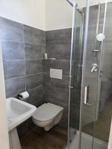 a bathroom with a toilet and a sink and a shower at Villa Ella by Interlux in Rimini +30 photos