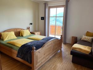 a bedroom with a wooden bed and a window at Kerschbamerhof im Süden Südtirols in Cortaccia +105 photos