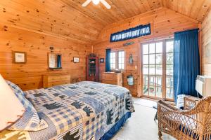 a bedroom with a bed in a wooden cabin at Lakefront Adirondacks Home Lake George Oasis! in Huletts Landing