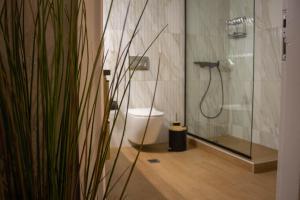 a bathroom with a toilet and a glass shower at Annis House in Epanomi +10 photos