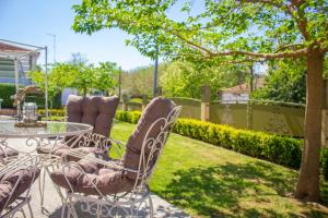 a patio with a table and chairs in a yard at Annis House in Epanomi