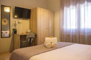 a hotel room with a bed with towels on it at Annis House in Epanomi