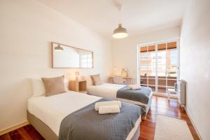 Ένα ή περισσότερα κρεβάτια σε δωμάτιο στο GuestReady - Sunny retreat near Boca do Inferno