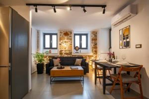 a living room with a couch and a table at Elements Syros Apartments in Ermoupoli