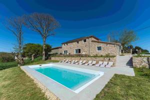 a house with a swimming pool in front of a building at Reverence Villas Caldelas in Antas de Ulla