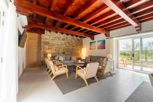 a living room with a couch and a table and chairs at Reverence Villas Caldelas in Antas de Ulla