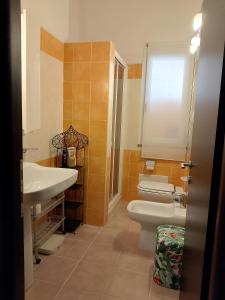 a bathroom with a sink and a toilet and a window at DreamHouse Miramare in Budoni +14 photos