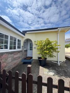 a house with a fence in front of it at Primley View in Goodrington
