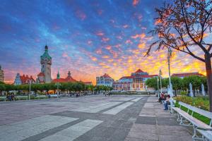 a city square with a clock tower and a cloudy sky at Sopot Modern Apartments 3 in Sopot