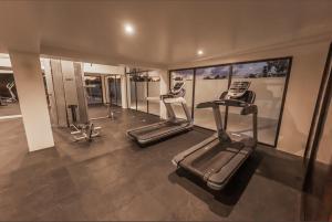 a gym with two tread machines in a room at Casa Reina Tulum in Tulum