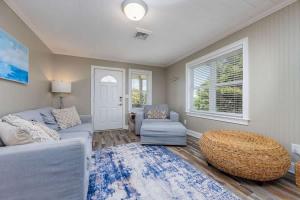 a living room with a couch and a chair at Private Pool Hot Tub and 4Min Walk to Beach in Kill Devil Hills +30 photos