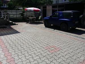 a blue truck parked on a brick road at Casa Anda in Sibiu