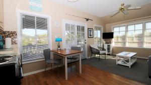 a kitchen and dining room with a table and chairs at 202 Ocean Unit 6 in Cape May Point +13 photos