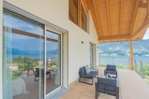 a balcony with a view of the water at Villa Cosima in Bellagio with Private Pool in Bellagio