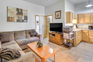 a living room with a couch and a table at Townsend Cottage on UTV and Snowmobile Trail! in Townsend