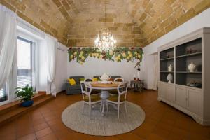 a dining room with a table and chairs in a room at Capo Rama Suites & Rooms in Terrasini