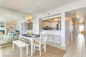 a dining room and kitchen with a table and chairs at Beachfront New Smyrna Condo: 1 Mi to Flagler Ave in New Smyrna Beach