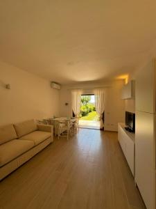 a living room with a couch and a table at Porto San Paolo Mono apartment in Porto San Paolo