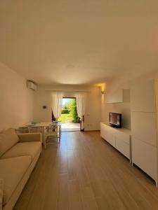 a living room with a couch and a table at Porto San Paolo Mono apartment in Porto San Paolo