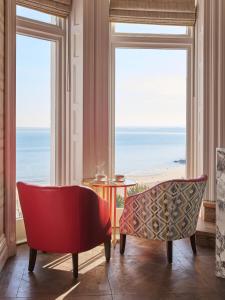 a living room with a view of the ocean at Harbour Hotel & Spa St Ives in St Ives